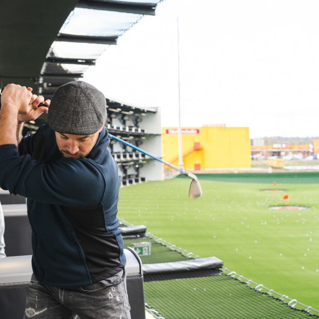 Man playing golf in modern golf location